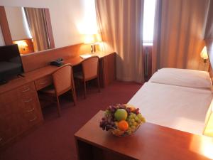 a hotel room with a bowl of fruit on a table at Abitohotel in Prague