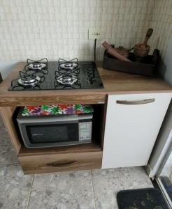 a kitchen with a stove and a counter top at Casa na canastra DUDU in São Roque de Minas