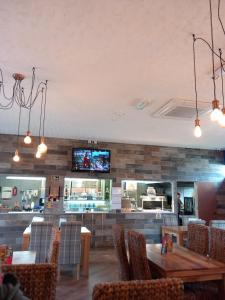 a restaurant with a table and chairs and a tv at Cosy comfort in Ingoldmells