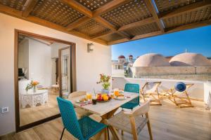 a dining room with a table and chairs at Casa Moazzo Suites and Apartments in Rethymno