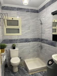 a bathroom with a toilet and a shower and a sink at Sun Mirror Chalet El Sokhna in Ain Sokhna
