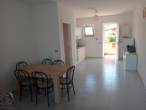 a kitchen and dining room with a table and chairs at trilocale "Alicudi" in Portorosa in Furnari