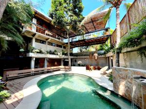 a swimming pool in the courtyard of a building at Nectar Hotel, Cafe, Cowork - Adults Only in Puerto Escondido