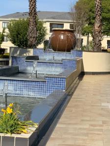 a water feature with a fountain in a yard at G Gold BNB in Fourways