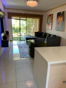 a living room with a couch and a table at G Gold BNB in Fourways
