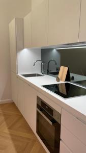 a kitchen with white cabinets and a stove top oven at City Apartment Downtown Vienna in Vienna