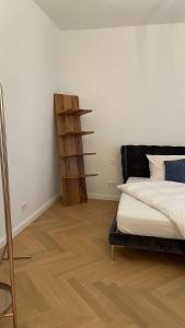 a bedroom with a bed and a wooden shelf at City Apartment Downtown Vienna in Vienna