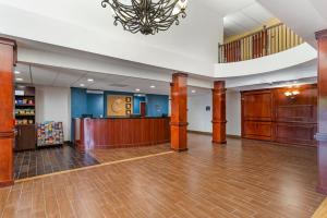 a large lobby with a waiting area and a chandelier at Comfort Suites Atlanta Airport in Forest Park