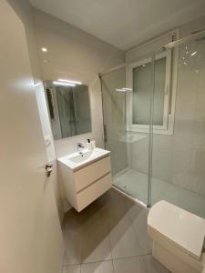 a bathroom with a sink and a shower and a toilet at Chalet en Aldán in Cangas de Morrazo