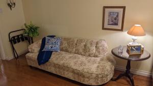 a living room with a couch and a table at Greater Toronto B&B in Oakville