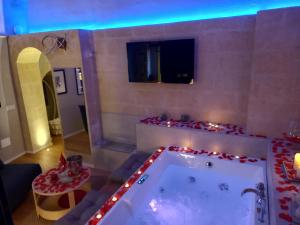 a large bathroom with a tub with christmas lights at SaxAurea in Matera