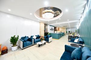 a waiting room with blue couches and a lobby at Hanoi Traveller House in Hanoi