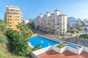 a swimming pool in a city with tall buildings at Gorgeous views close to Marina! in Estepona