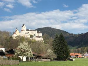 a large building on top of a mountain at ciao-aschau Haus zur Burg Ap112 Burgblick in Aschau