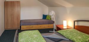 a small room with two beds and a lamp at Apartmán na Koskách in Třeboň