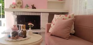 a living room with a pink couch and a fireplace at ViLLETTA CLAUDETTA in Laveno-Mombello