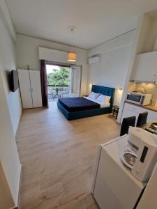 a small living room with a bed and a kitchen at Above Apartments near the Airport in Artemida