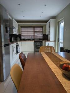 a kitchen with a wooden table with chairs and a dining room at Entire House with Mountain view in Moneymore