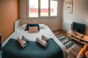 a bedroom with a bed with three pillows on it at Studio Falquet - Proche vieille ville in Annecy