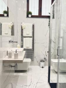 a white bathroom with two sinks and a shower at La casa di Apollo in Acireale +25 photos