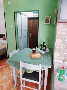 a kitchen with a table and a refrigerator at Apartman PAVLE in Plužine