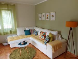 a living room with a white couch and a table at Apartments Iva in Tivat