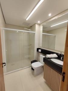 a bathroom with a shower and a toilet and a sink at Estilo suit in Sao Paulo