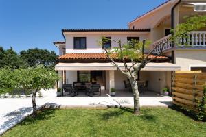 a view of a house with a patio at Casa Pinia with outdoor jacuzzi in Poreč