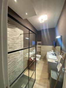 a bathroom with two sinks and a toilet and a mirror at Vista Eolie Milazzo- Apartments in Milazzo +237 photos