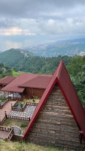 a building with a red roof on top of it at Antikhouse Bungalow&Cafe in Akcaabat
