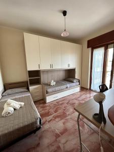 a bedroom with two beds and a table in it at Mare qui in Gaeta +21 photos
