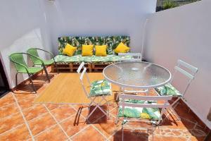 a living room with a couch and chairs and a table at Impeccable 2-Bed House in Guia de Isora in Guía de Isora