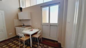 a small kitchen with a white table and chairs at Residenza La Terrazza locazione turistica in Bari