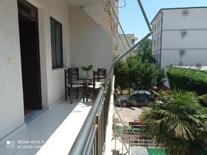 a balcony of a house with a table and chairs at A & H Apartments Velipoje in Velipojë