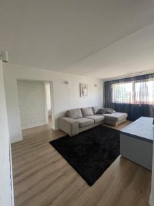 a living room with a couch and a rug at Tallinn Street Apartment in Kuressaare