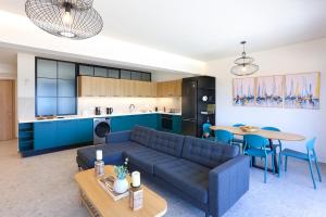 a living room and kitchen with a couch and a table at Dione Seaside Apartments in Hersonissos