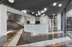 a lobby with a reception desk in a building at Astria Boutique Apartments 301 in Olimp