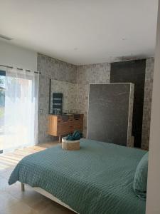 a bedroom with a bed and a chalkboard on the wall at Villa au calme in Montauroux