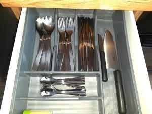 a drawer with silver utensils in it at Apartament Wawa in Warsaw