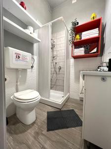 a bathroom with a white toilet and a shower at Aria Di Casa in Rome