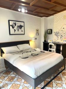 a bedroom with a large bed and a desk at Aria Di Casa in Rome