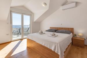 a bedroom with a large bed and a balcony at Villa Mirela in Petrcane +147 photos
