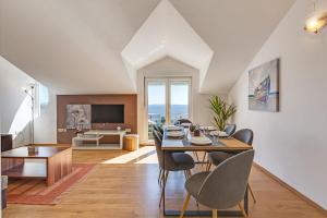 a dining room and living room with a table and chairs at Villa Mirela in Petrcane