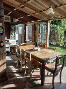 a wooden table and chairs on a patio at Gramado Guest House in Gramado