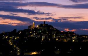 a city lit up at night with a city at Ferruccio's House in Colonnella