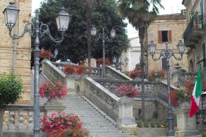 a set of stairs with flowers and lights and street lights at Ferruccio's House in Colonnella