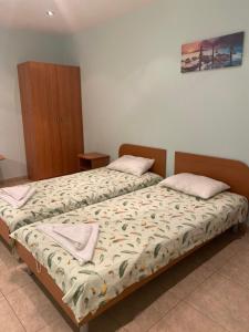 a bedroom with two beds with towels on them at Sozopol For Two in Sozopol