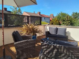 a patio with two chairs and an umbrella at Holland House in New Brighton