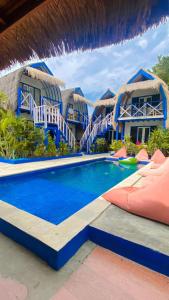 a swimming pool in front of a resort at Tropical House Bungalows in Gili Trawangan