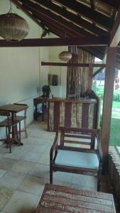 a room with a chair and tables and a table at Pousada Sunbrazil in Jericoacoara